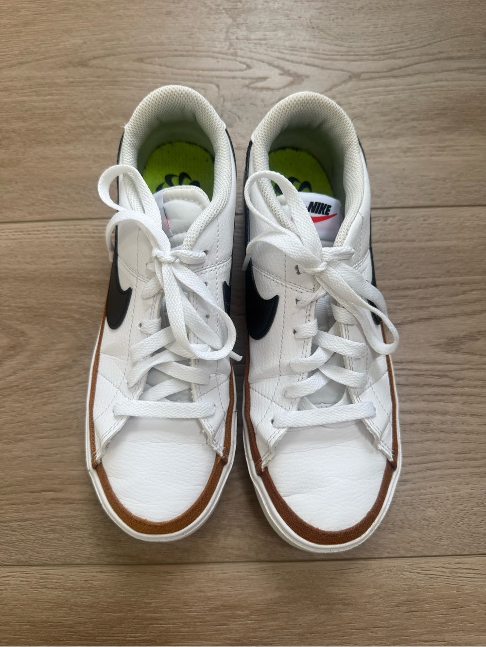 Nike White Low-Top Sneakers with Black Swoosh and Brown Trim